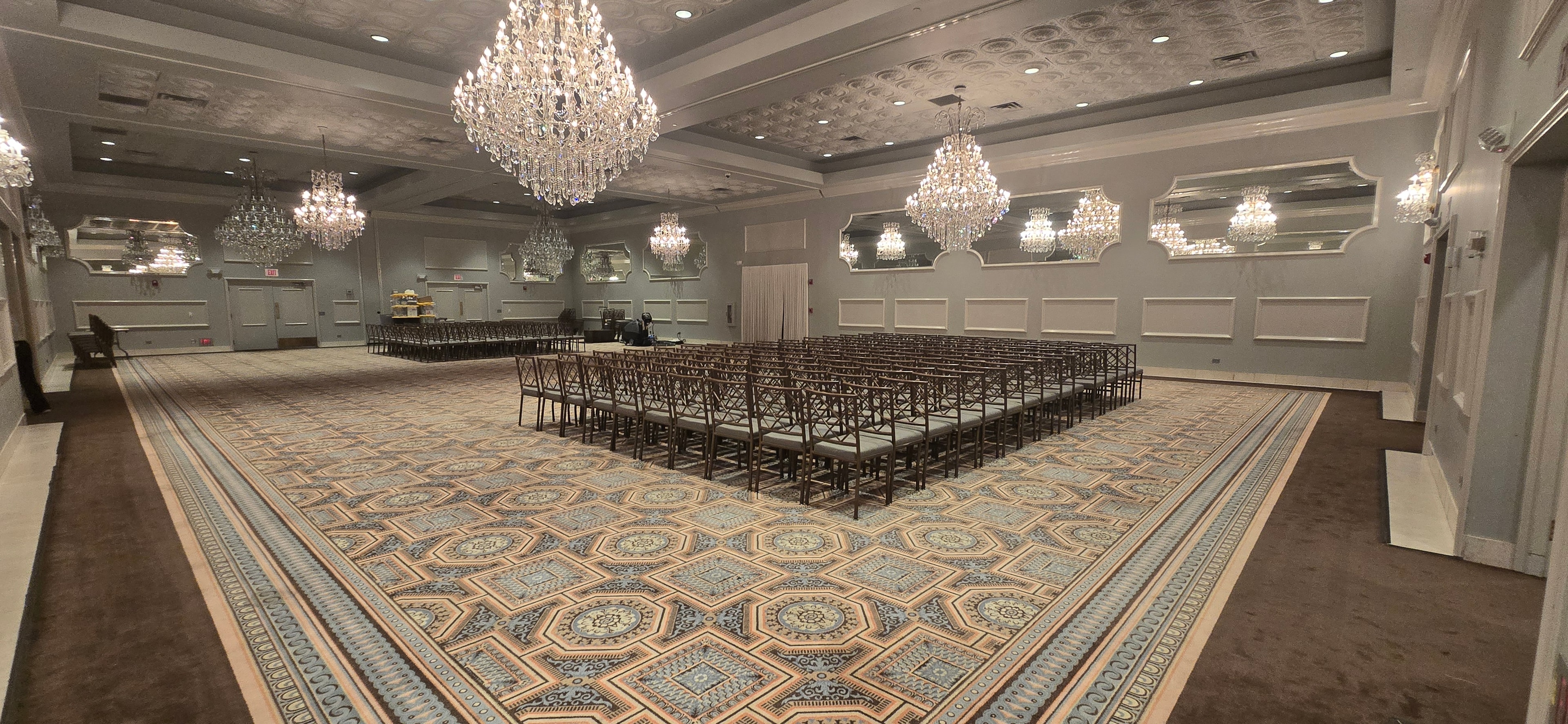 Drury Lane ballroom set for the 2026 RUSH University Graduation ceremony — crystal chandeliers and formal seating arrangement
